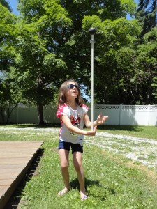 Elizabeth tries to balance COSI's rod and learns an object lesson in gravity and momentum.