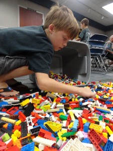 Alec searches for just the right Lego piece among the morass.