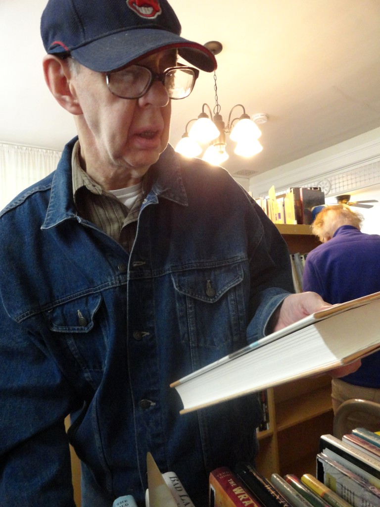 Doug Reed helps shelve books in the house where he used to live. The Read House is now owned by Mentor Public Library.