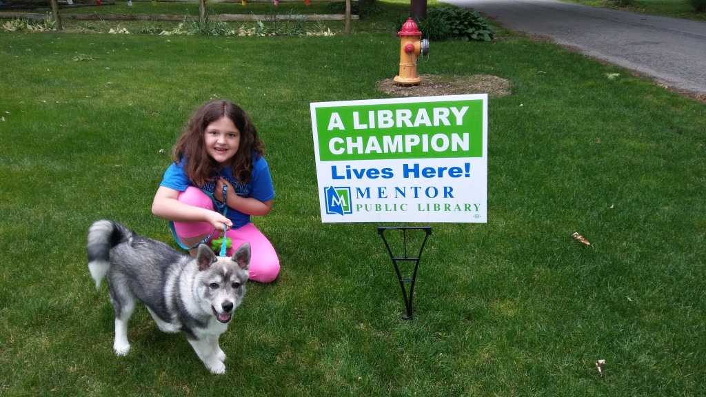 To be clear, the girl and not the dog is the library champion. The dog is a good dog but Elizabeth is a CHAMPION.