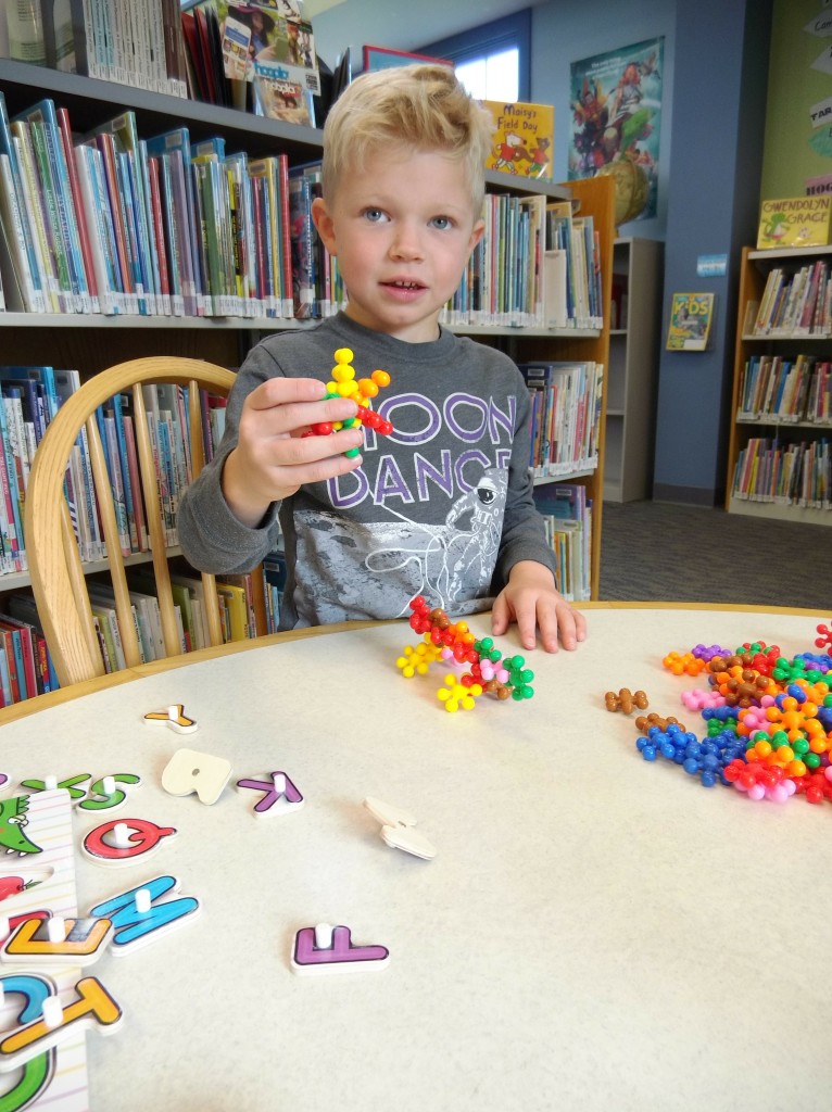 Nolan builds an iguana and a star out of the EMIDO blocks at Lake Branch’s new STEAM station.