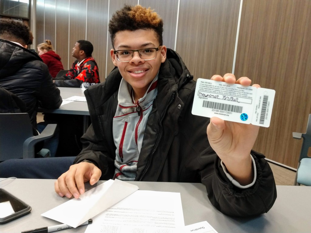One of the Career Technical Education students shows off his new Mentor Public Library card.