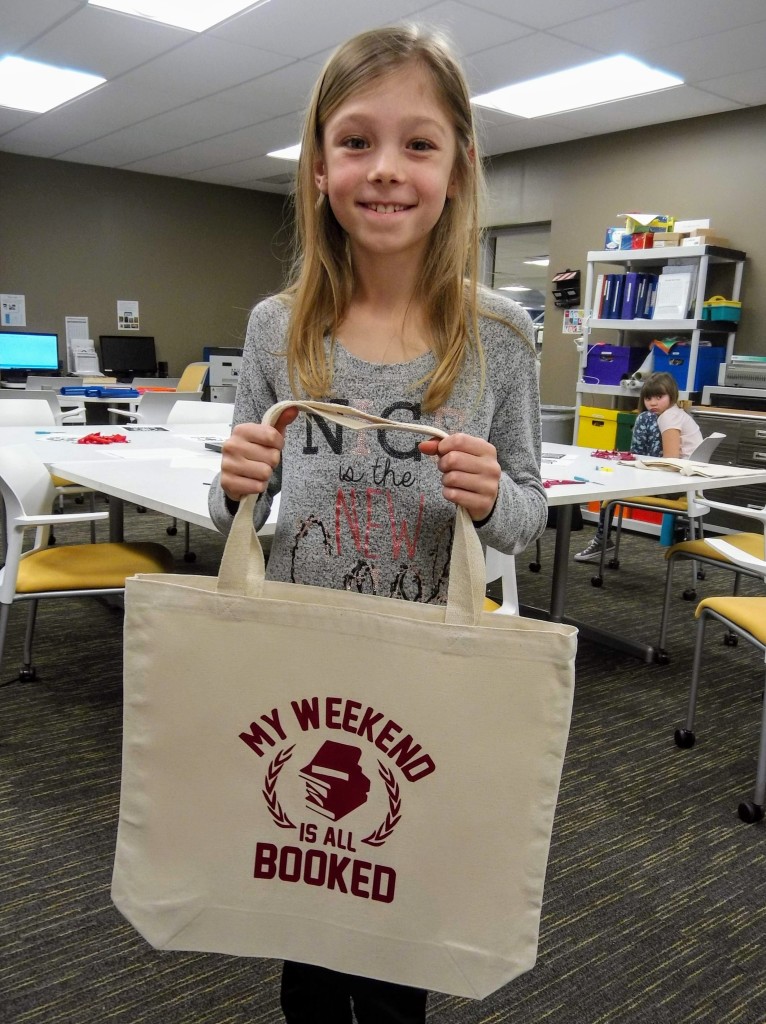 Gwen shows the custom tote bag she made at The HUB's makerspace.