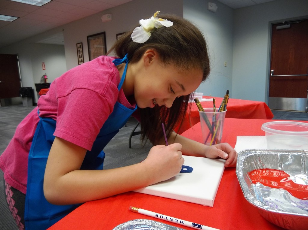Emma seeks inspiration from Frida Kahlo during our art program on Tuesday.