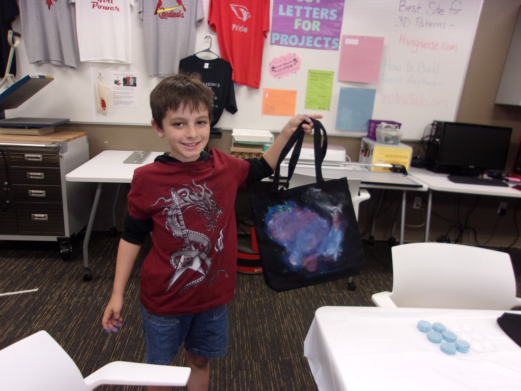 Eli shows off the stellar tote bag he customized at The HUB.