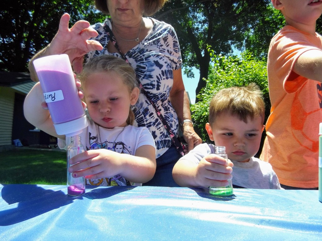 Kids fill their bottles with colorful sand on another Marvelous Monday on our Main Branch lawn.